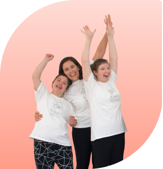 teacher Miss Annabelle is smiling with two student either saide of her with their arms up high having lots of fun