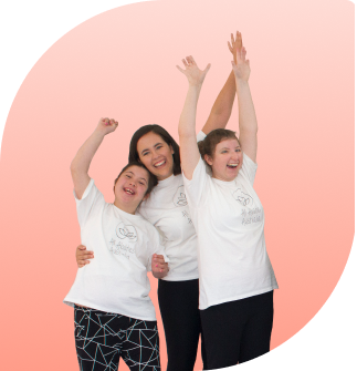 Teacher, Miss Annabelle and a student sitting in her wheelchair are posing happily for a photo with their All Abilities Australia shirts